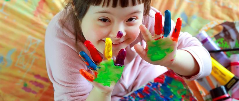 Child playing with colors